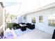 A cozy, covered patio with stylish seating, a fire pit, and a bright, patterned rug at 4217 Avanti Cir, New Port Richey, FL 34655