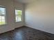 This bedroom features wood-look tile flooring and a bright, neutral palette perfect for personalization at 25126 Calusa Dr, Punta Gorda, FL 33955