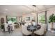 Bright living room with a dining table set for six and natural light with an open floor plan at 25126 Calusa Dr, Punta Gorda, FL 33955