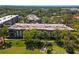 Aerial shot of the condo community surrounded by mature trees and well-manicured lawns at 3035 Countryside Blvd # 15B, Clearwater, FL 33761