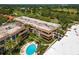 Aerial view of condo community with pool and lush tropical landscaping offering a resort-style living at 3035 Countryside Blvd # 15B, Clearwater, FL 33761