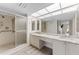Bathroom features a dual sink vanity, tiled shower, and accessibility bars at 3035 Countryside Blvd # 15B, Clearwater, FL 33761
