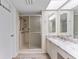 Bathroom with a dual sink vanity, tiled shower, and accessibility bars at 3035 Countryside Blvd # 15B, Clearwater, FL 33761