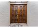 Elegant front door with intricate carvings, accented by neutral walls and a floral rug at 3035 Countryside Blvd # 15B, Clearwater, FL 33761