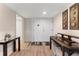 Bright foyer with a hardwood floor, featuring an accent table, closet and decorative console table at 3035 Countryside Blvd # 15B, Clearwater, FL 33761