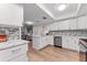 Updated kitchen with granite counters, stainless appliances, tile backsplash, and breakfast bar at 3035 Countryside Blvd # 15B, Clearwater, FL 33761