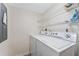Functional laundry area equipped with a modern washer and dryer and practical wire shelving at 3035 Countryside Blvd # 15B, Clearwater, FL 33761