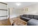 Inviting living room featuring a comfortable gray couch, neutral walls, area rug and wood-style flooring at 3035 Countryside Blvd # 15B, Clearwater, FL 33761