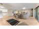 Expansive living room with hardwood floors, neutral decor, and a view into the kitchen at 3035 Countryside Blvd # 15B, Clearwater, FL 33761