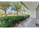 Charming outdoor patio with decorative plants and views of a lush, green golf course beyond at 3035 Countryside Blvd # 15B, Clearwater, FL 33761
