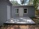 The light gray backyard deck provides the perfect outdoor space to relax or entertain, with access to the house at 8306 N Orleans Ave, Tampa, FL 33604