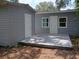 The light gray backyard deck provides the perfect outdoor space to relax or entertain, with access to the house at 8306 N Orleans Ave, Tampa, FL 33604
