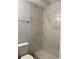 Modern bathroom features marble tile shower and tiled floor at 8306 N Orleans Ave, Tampa, FL 33604