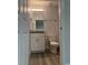 Bathroom featuring vanity, toilet and tile surround at 8306 N Orleans Ave, Tampa, FL 33604