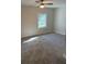 Cozy bedroom with ceiling fan, window and neutral carpet at 8306 N Orleans Ave, Tampa, FL 33604
