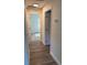 Hallway featuring wood-look floors and doorways to rooms at 8306 N Orleans Ave, Tampa, FL 33604