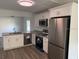 Beautiful eat-in kitchen featuring new stainless-steel appliances and granite countertops at 8306 N Orleans Ave, Tampa, FL 33604