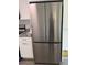 New stainless steel refrigerator in a modern kitchen with white cabinets and granite countertops at 8306 N Orleans Ave, Tampa, FL 33604