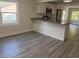 Open kitchen with granite countertops, white cabinets, and stainless steel appliances at 8306 N Orleans Ave, Tampa, FL 33604