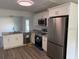 Modern kitchen boasts stainless steel appliances, granite countertops, and ample cabinet space at 8306 N Orleans Ave, Tampa, FL 33604