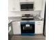 New stainless-steel oven and microwave installed in a bright, modern kitchen with white cabinets at 8306 N Orleans Ave, Tampa, FL 33604
