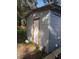 Backyard shed featuring metal siding and a wooden trimmed door at 8306 N Orleans Ave, Tampa, FL 33604