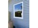 An exterior view of window with white trim, reflecting the outdoor sky at 8306 N Orleans Ave, Tampa, FL 33604