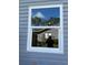 New white window with a neighborhood view reflecting in the glass at 8306 N Orleans Ave, Tampa, FL 33604