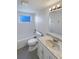 Updated bathroom with white vanity, granite countertop and tile flooring at 9210 Crabtree Ln, Port Richey, FL 34668
