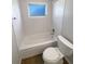 White bathroom with shower and tub combo, including a new toilet at 9210 Crabtree Ln, Port Richey, FL 34668