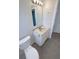 Updated bathroom featuring a toilet, sink, vanity with granite countertop, and gray tiling at 9210 Crabtree Ln, Port Richey, FL 34668