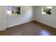 This cozy bedroom has tile flooring and two windows at 9210 Crabtree Ln, Port Richey, FL 34668