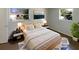 Bright bedroom featuring a comfortable bed, stylish nightstands, and natural light from the windows at 9210 Crabtree Ln, Port Richey, FL 34668