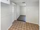 Bright dining area with neutral paint, tile flooring and access to other rooms at 9210 Crabtree Ln, Port Richey, FL 34668