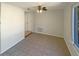 Open-plan living room with ceiling fan and windows bringing natural light at 9210 Crabtree Ln, Port Richey, FL 34668
