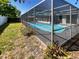 Spacious in-ground pool with a screened enclosure, providing a private and refreshing outdoor oasis at 9210 Crabtree Ln, Port Richey, FL 34668