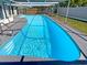 Beautiful in-ground pool with steps and clear blue water, perfect for relaxation and recreation at 9210 Crabtree Ln, Port Richey, FL 34668