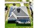 Aerial view of home with solar panels, pool, and screened-in lanai, surrounded by a well-kept lawn at 2248 Bonn Ct, Punta Gorda, FL 33983