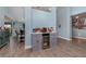 Elegant bar area featuring custom cabinets, a beverage fridge, grey walls, and stylish floors at 2248 Bonn Ct, Punta Gorda, FL 33983