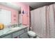 Bathroom with a gray vanity and marble countertop, shower with a pink shower curtain and princess wall decor at 2248 Bonn Ct, Punta Gorda, FL 33983
