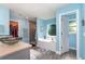 Bathroom featuring a glass bowl sink, walk-in closet, tiled shower, and soaking tub under a window at 2248 Bonn Ct, Punta Gorda, FL 33983