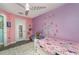 Bedroom with princess-themed decor, a ceiling fan, a white bed frame, and a fluffy white rug at 2248 Bonn Ct, Punta Gorda, FL 33983