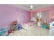 Bedroom with princess-themed decor, a ceiling fan, a white bed frame, and a fluffy white rug at 2248 Bonn Ct, Punta Gorda, FL 33983