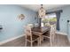 Bright dining room featuring a wooden table, six chairs, stylish lighting, and a window with lots of natural light at 2248 Bonn Ct, Punta Gorda, FL 33983