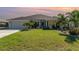 Charming one-story home boasts a well-manicured lawn and beautiful landscaping at 2248 Bonn Ct, Punta Gorda, FL 33983