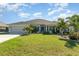 Charming single-story home with a well-manicured lawn and lush tropical landscaping at 2248 Bonn Ct, Punta Gorda, FL 33983