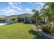 Charming single-story home featuring a well-manicured lawn, beautiful landscaping and a two car garage at 2248 Bonn Ct, Punta Gorda, FL 33983