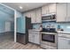 Kitchen featuring stainless steel appliances, grey cabinets and light blue backsplash at 2248 Bonn Ct, Punta Gorda, FL 33983