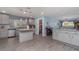 Stylish kitchen featuring modern cabinets, an island, an open doorway, and lots of natural light at 2248 Bonn Ct, Punta Gorda, FL 33983