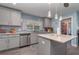 Kitchen with stainless appliances, tiled backsplash, and center island at 2248 Bonn Ct, Punta Gorda, FL 33983